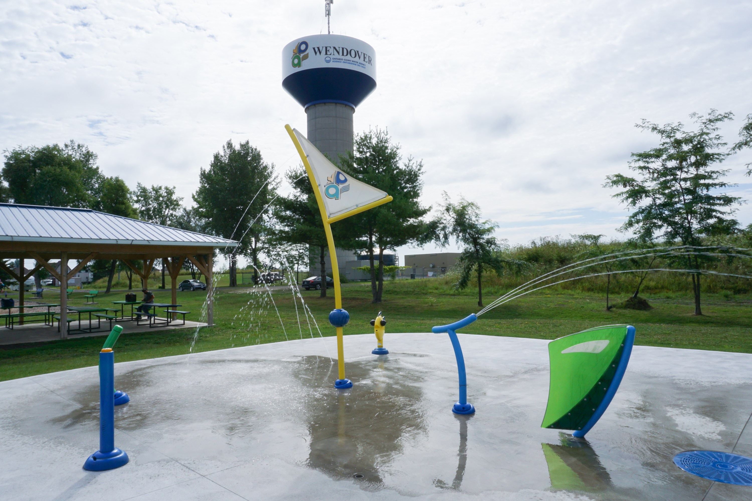 View of the Splashpad at the Denis St-Pierre Park, the water tower and a gazebo